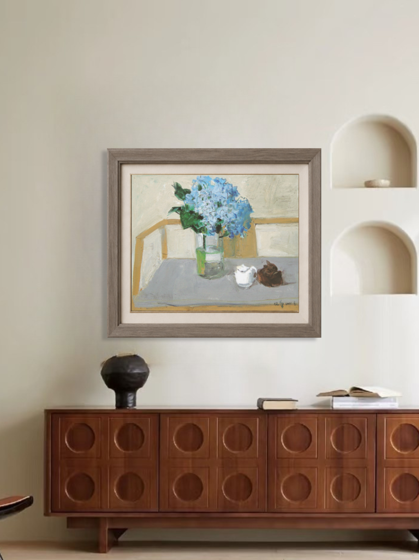 Framed oil painting featuring blue hydrangea flowers displayed in a modern interior, creating a calm and sophisticated focal point.