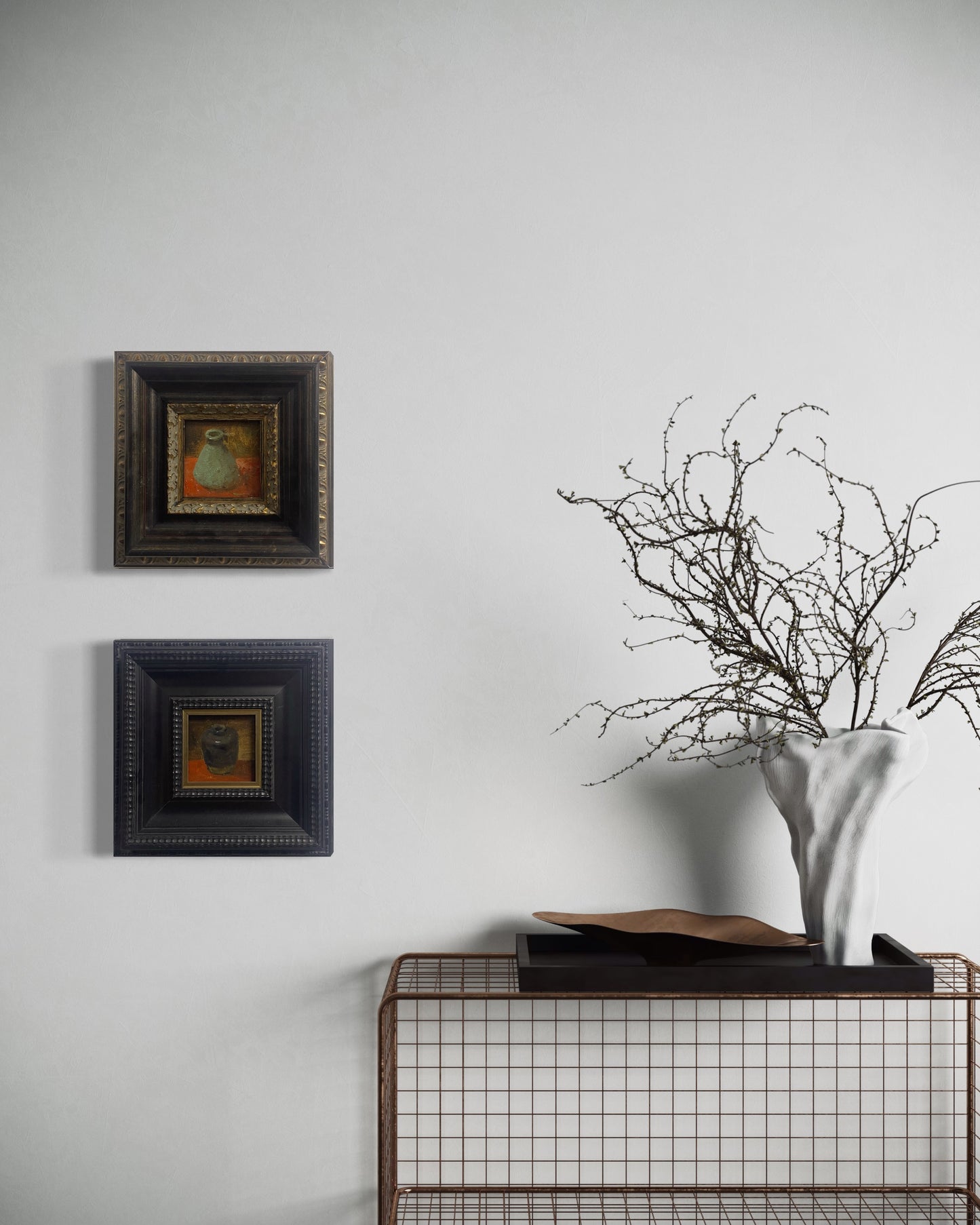 Two small original still life oil paintings displayed vertically in deep black frames, styled for sophisticated contemporary interiors.
