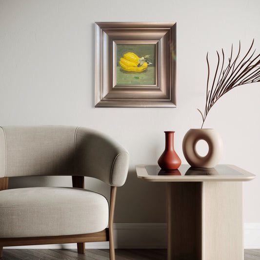 A framed still life oil painting of a yellow squash displayed in a warm minimalist interior with soft neutral tones, modern furniture, and quiet decorative objects, creating a calm and collected atmosphere.
