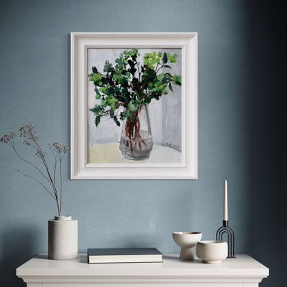 Original greenery still life oil painting styled against a blue-grey wall in a modern interior with calm decorative accents.
