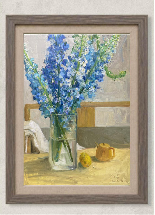 Original oil painting featuring blue delphinium flowers arranged in a clear glass vase beside lemons on a tabletop. Painted by Hua Xi Yang with luminous color contrasts and a refined floral still life composition.