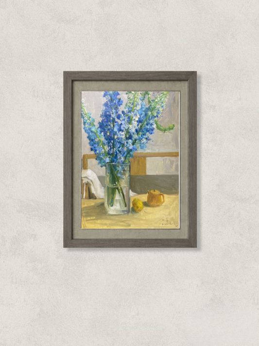 Original oil painting featuring blue delphinium flowers arranged in a clear glass vase beside lemons on a tabletop. Painted by Hua Xi Yang with luminous color contrasts and a refined floral still life composition.