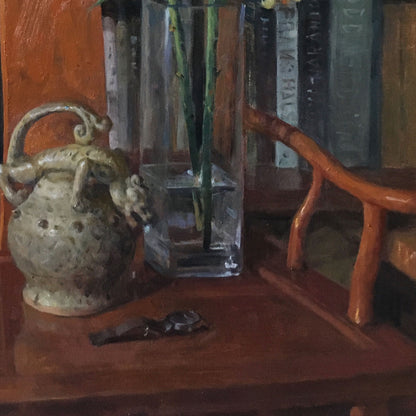 Detail of a ceramic vessel, books, and wooden tabletop, highlighting texture, depth, and the quiet character of everyday objects.