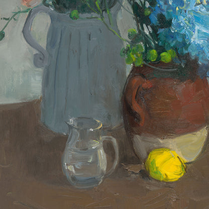 Close-up of ceramic vessels, a glass cup, and a lemon, emphasizing texture, transparency, and the balance of everyday objects within the composition.