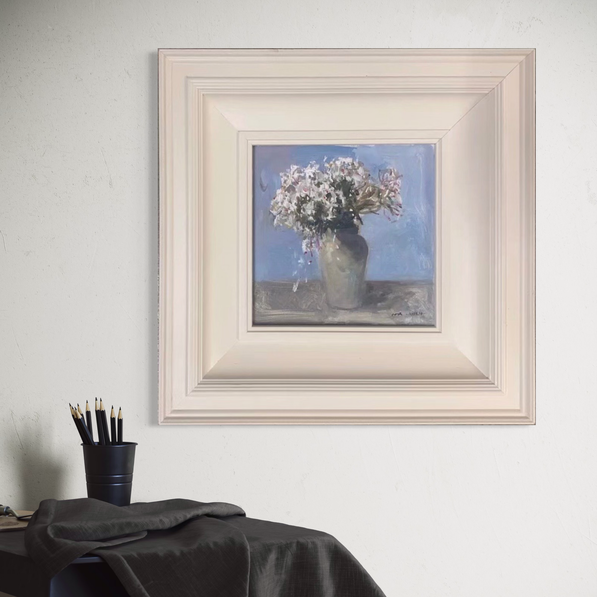 Original white floral oil painting in a soft ivory frame styled in a warm minimalist interior with gentle natural lighting.