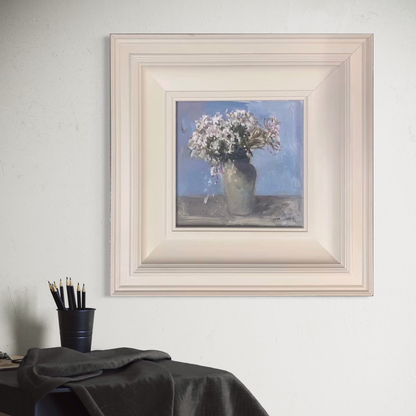 Original white floral oil painting in a soft ivory frame styled in a warm minimalist interior with gentle natural lighting.