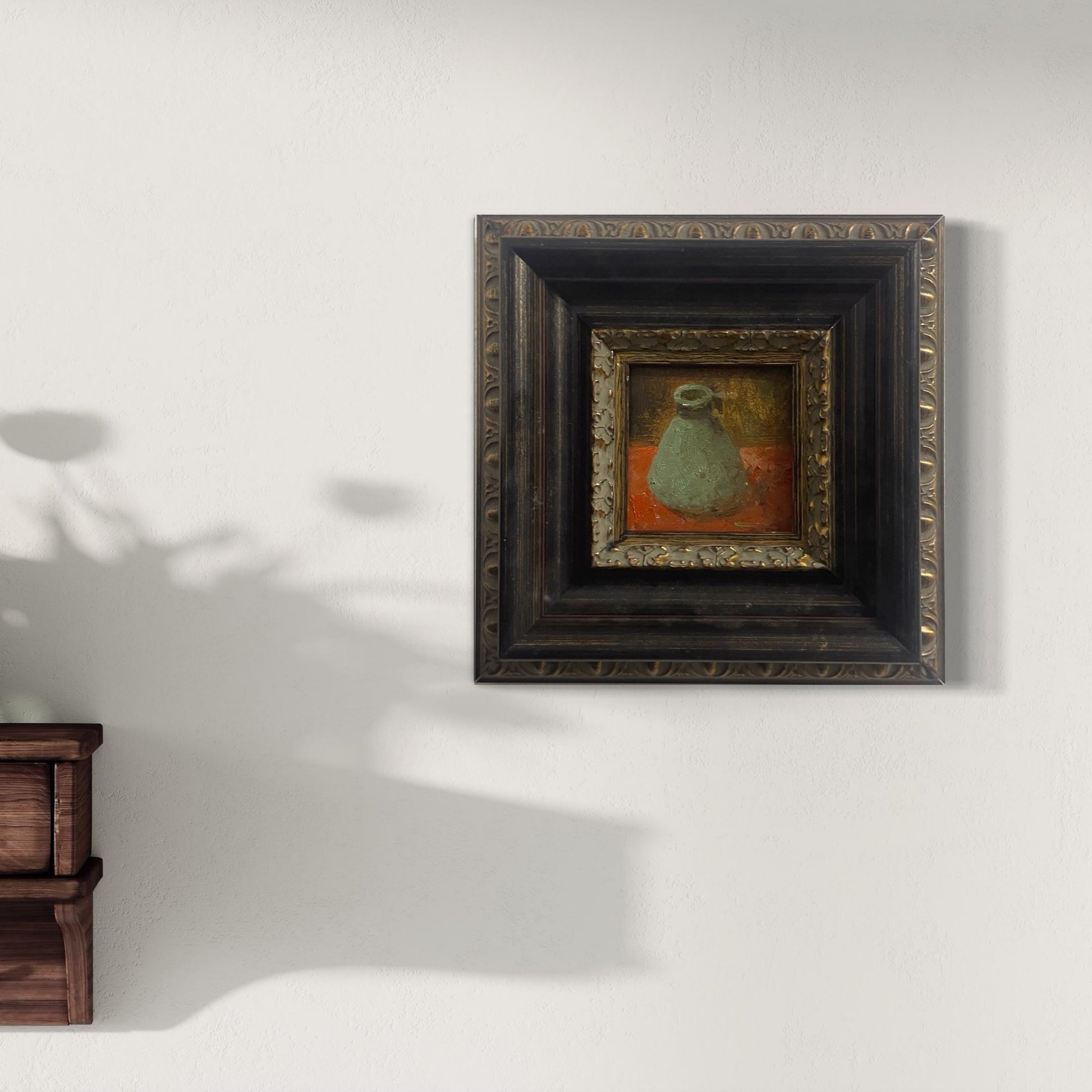 替代文本：
Small classical still life oil painting in a dark gallery frame styled on a softly lit neutral wall with natural sunlight.