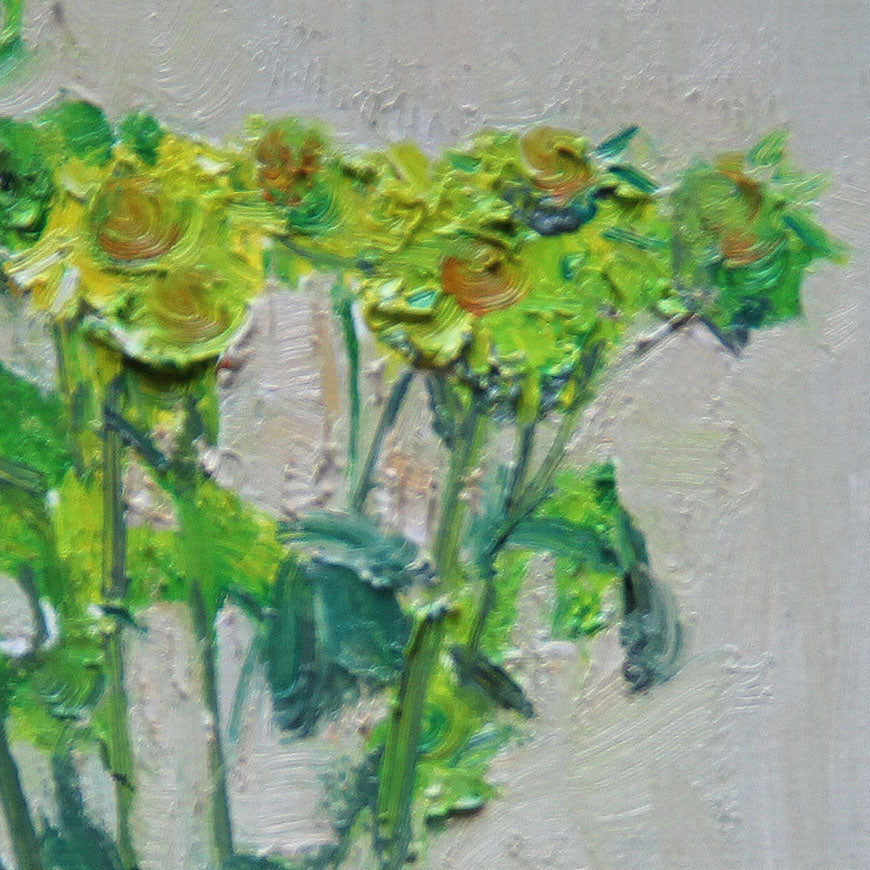 Framed still life oil painting of green flowers styled above a wooden console table. The restrained composition and muted colors create a peaceful gallery-style atmosphere.