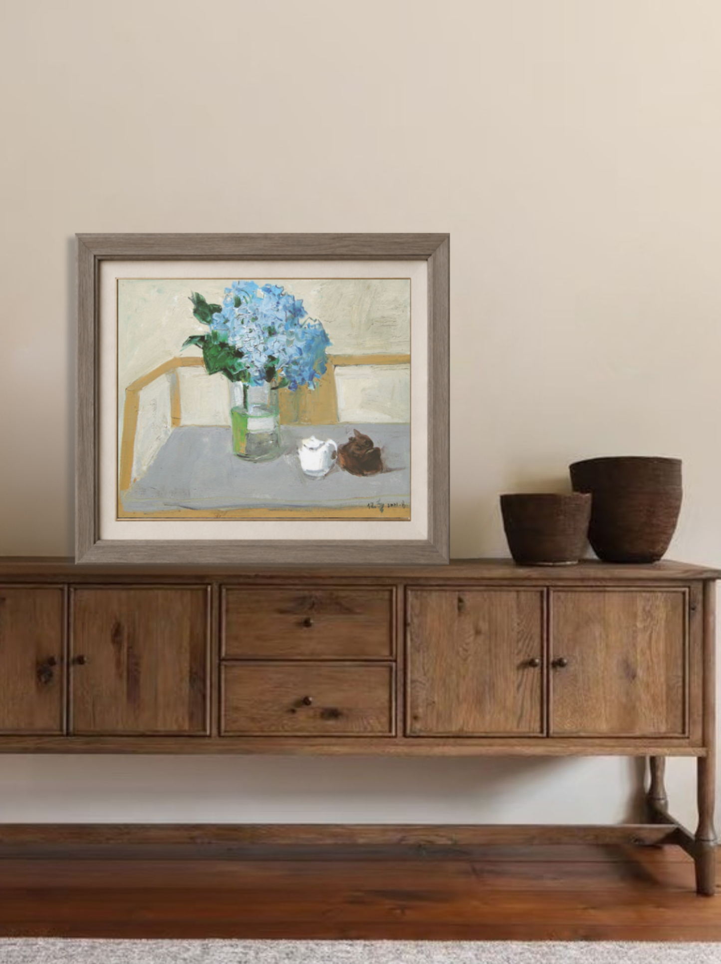 Original blue hydrangea still life oil painting displayed above a wooden cabinet, bringing softness and elegance to a contemporary interior.