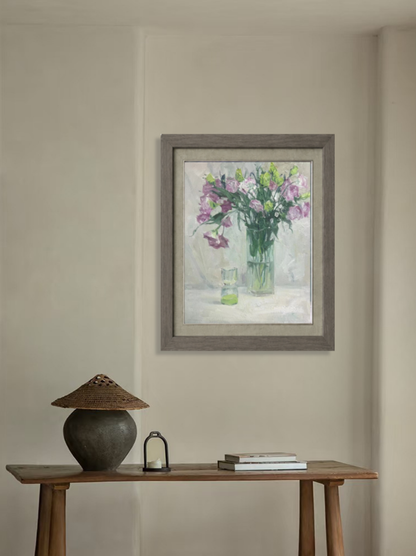 Original floral still life oil painting displayed in a quiet interior setting, bringing softness, color, and artistic presence to the space.