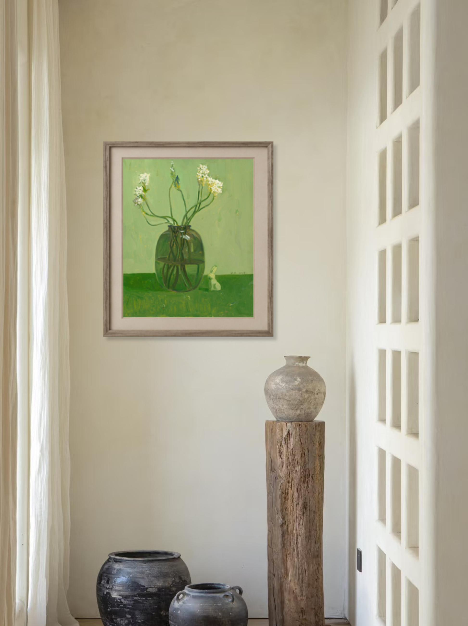Original floral still life painting displayed in a calm interior setting, bringing soft green tones and natural elegance to the space.