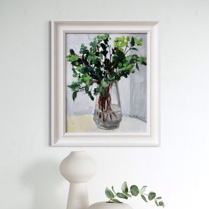 Original greenery still life oil painting framed in soft ivory wood and styled in a calm minimalist interior with sculptural ceramic decor.