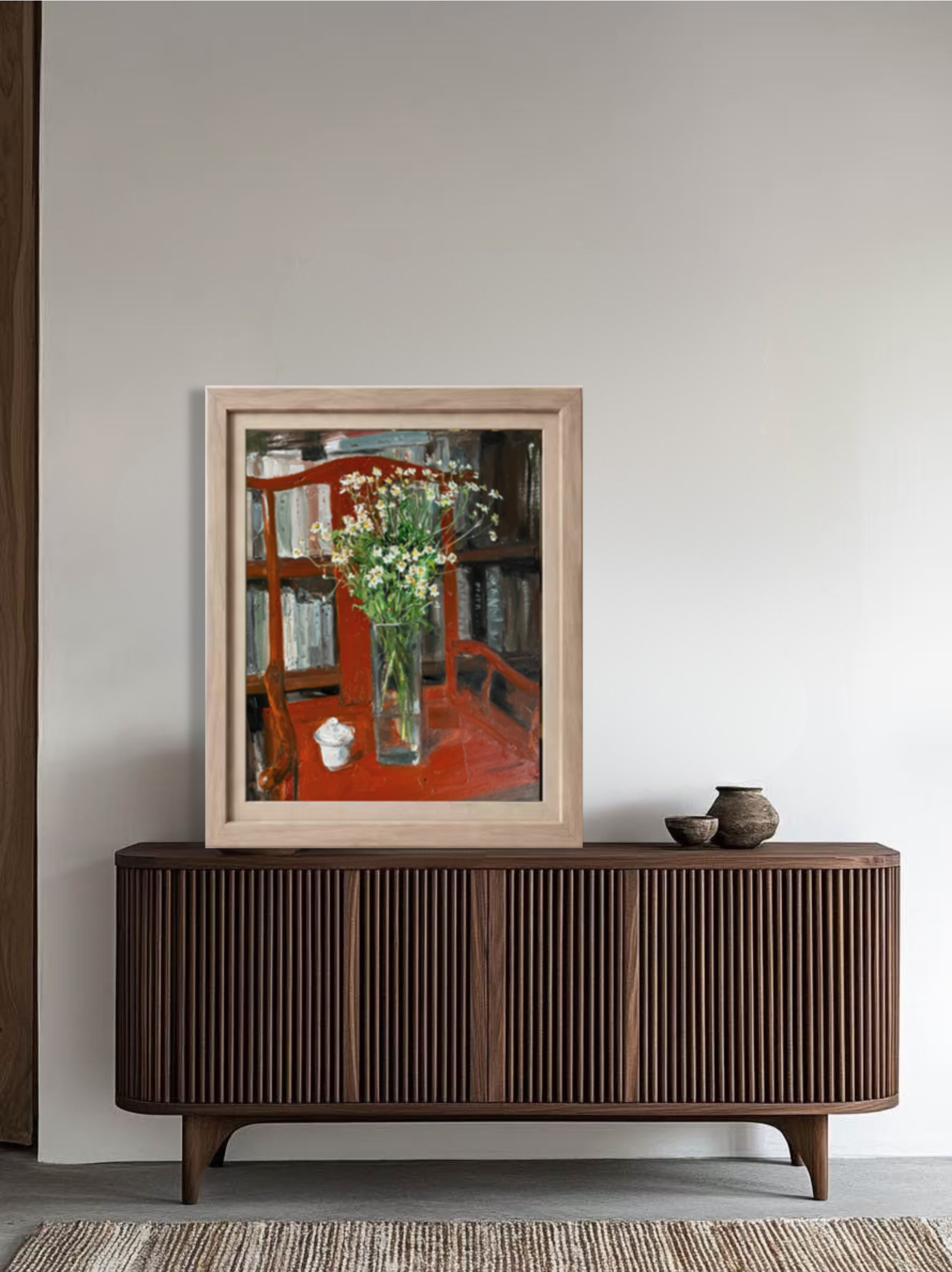 Framed original still life oil painting displayed above a wooden cabinet, bringing vivid red tones and refined artistic presence to the interior.