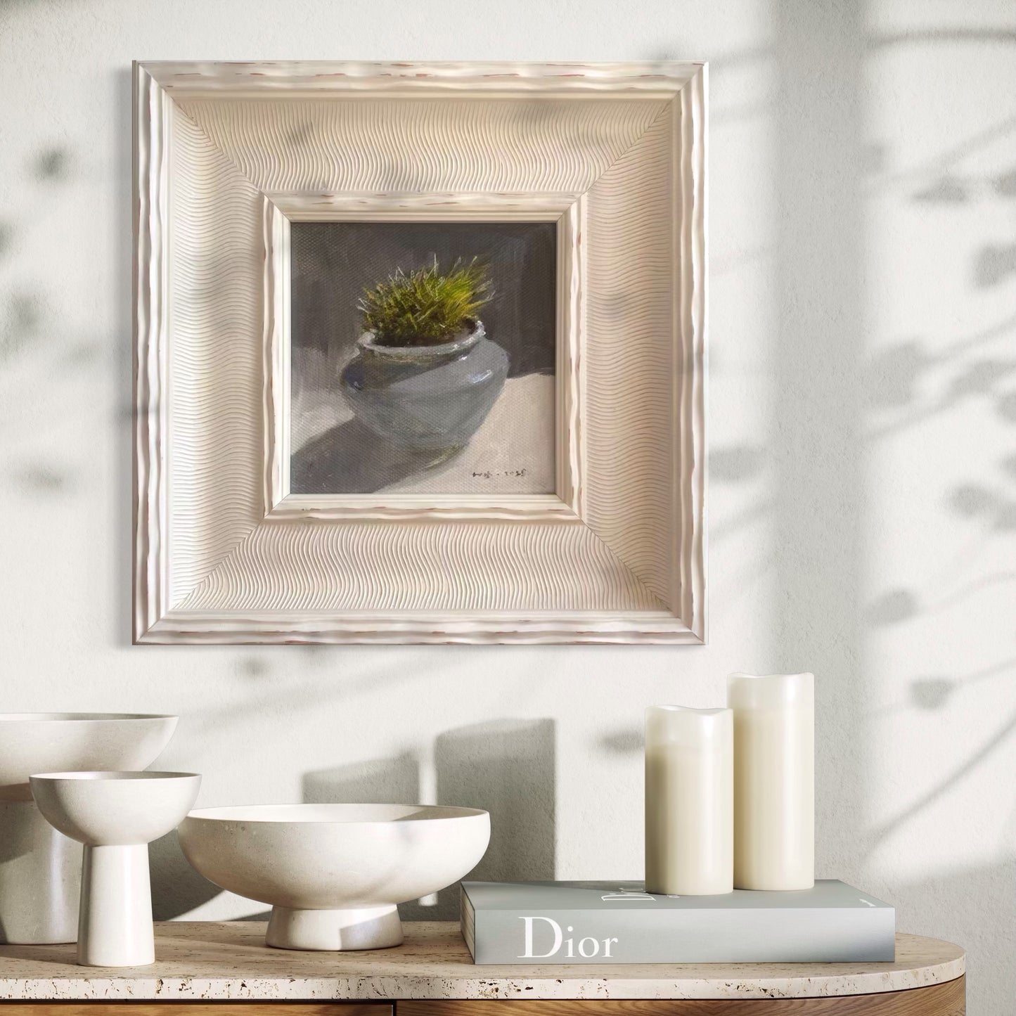 A framed original succulent oil painting styled within a calm neutral interior featuring books, ceramics, and soft natural light. The painting adds subtle texture and quiet presence to the modern living space.