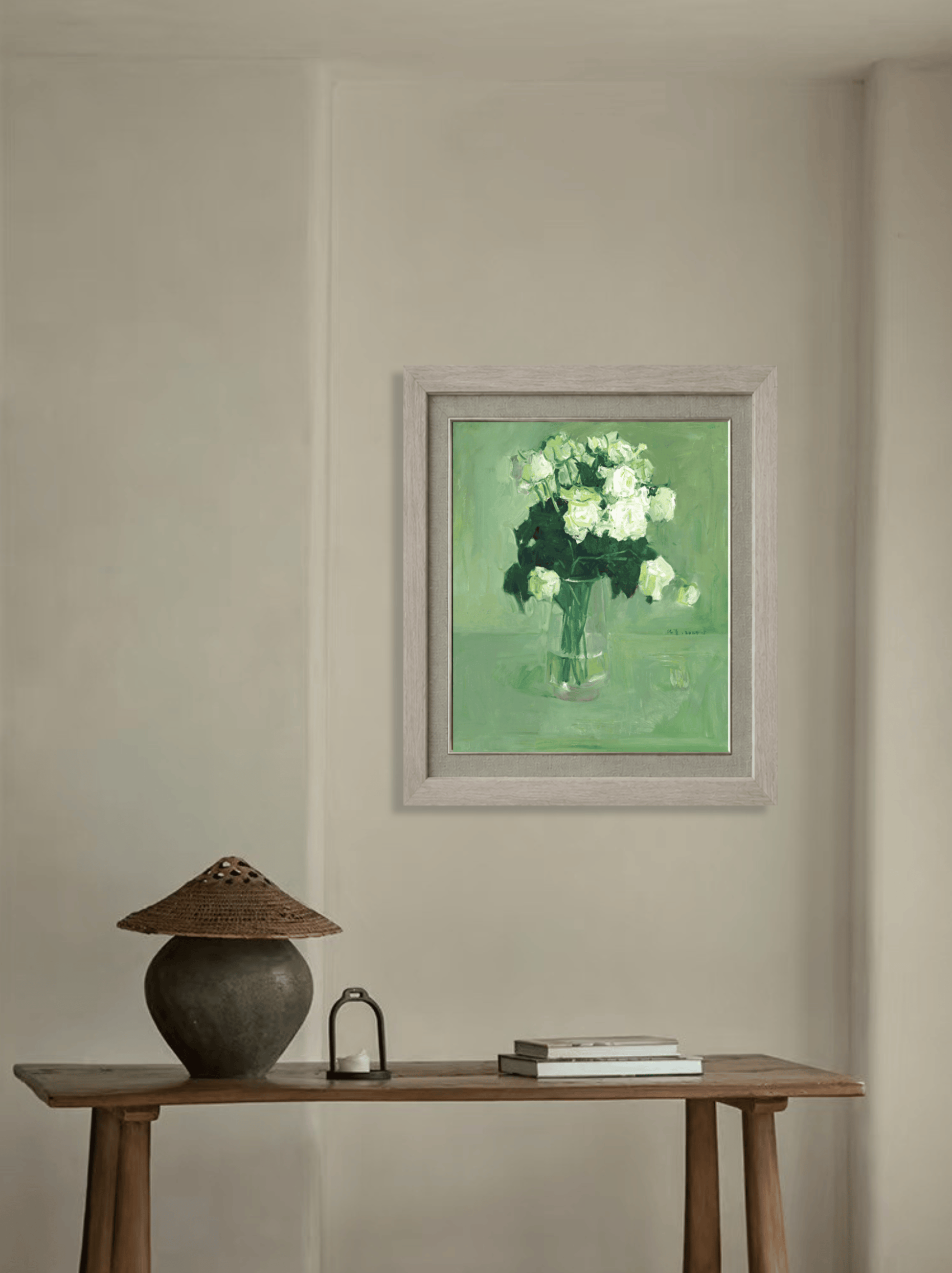 Original white rose still life painting displayed on a neutral wall with simple furniture, illustrating its suitability for contemporary and refined interior spaces.