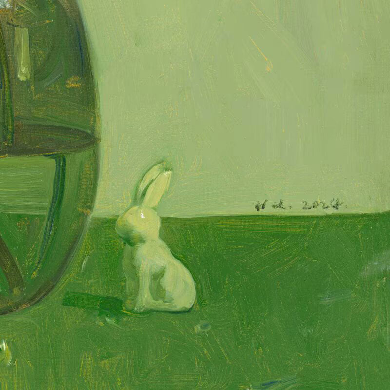 Detail of the green glass vase with white flowers and small decorative rabbit, showing reflections, texture, and quiet still life arrangement.