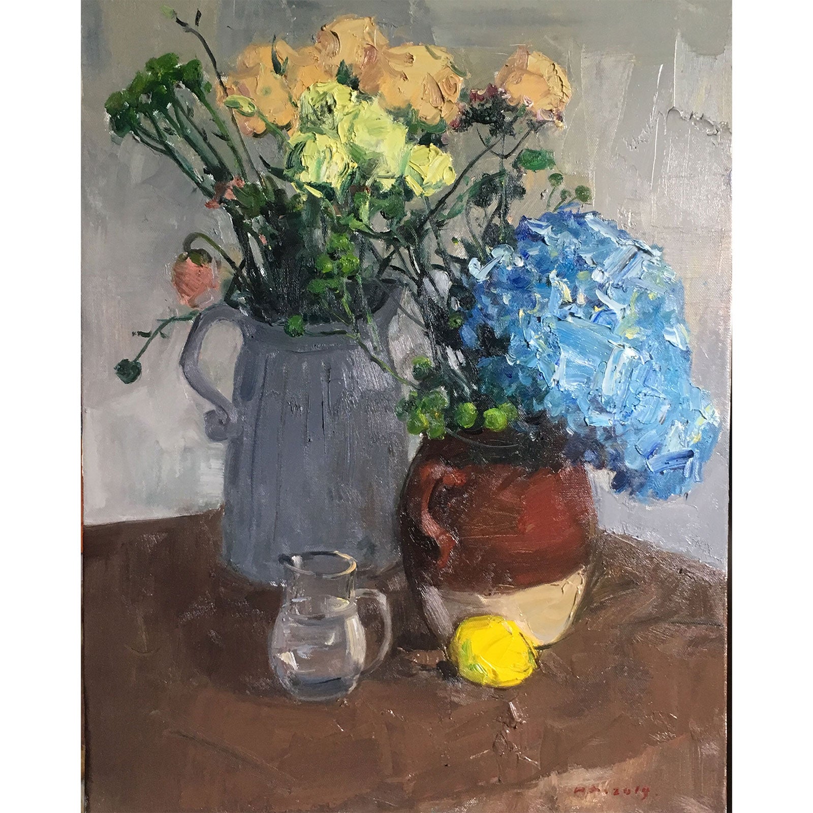 Detail of blue hydrangea, yellow roses, ceramic vessels, and tabletop objects, revealing depth, color harmony, and a warm still life atmosphere.