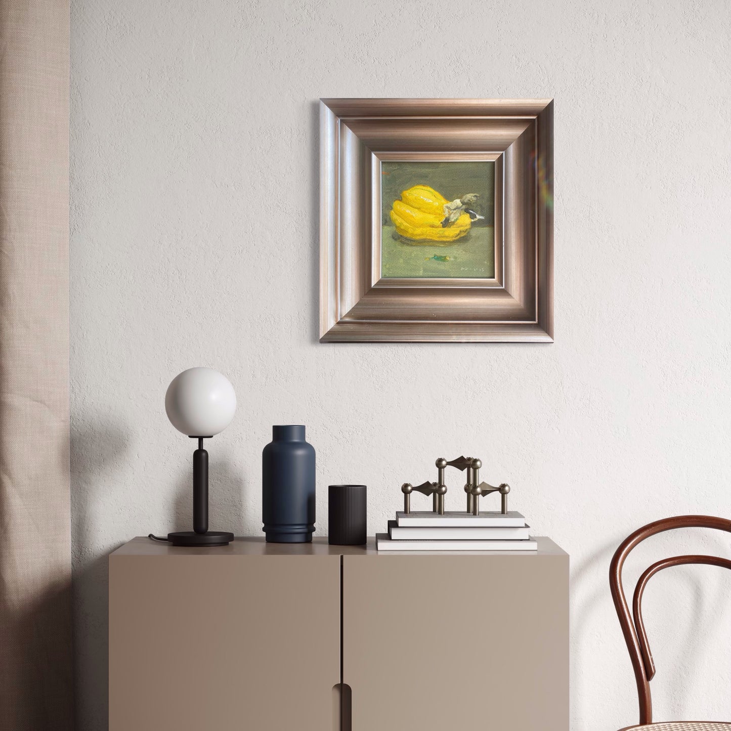 A miniature still life oil painting styled in a neutral contemporary room with soft beige walls and minimal furnishings, bringing subtle color and painterly texture into the space.