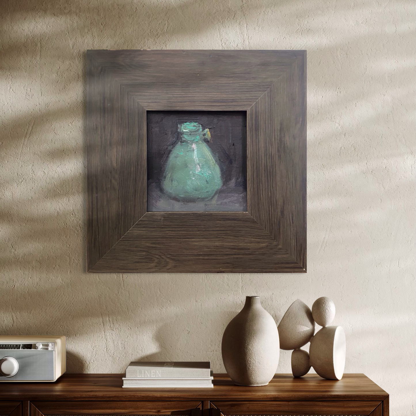 A small original still life oil painting displayed in a neutral interior space. The weathered wooden frame and soft lighting give the artwork a grounded and timeless presence.
