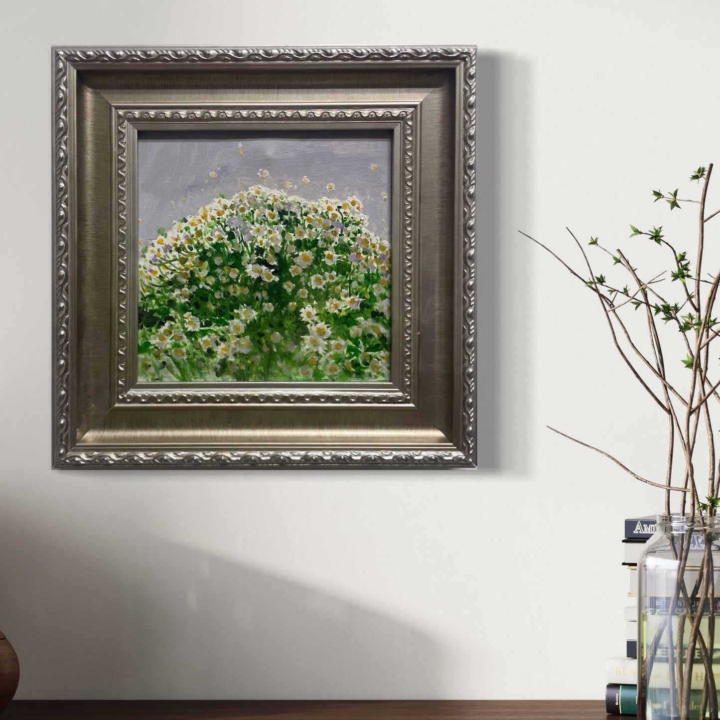 An original floral oil painting styled in a contemporary neutral room with natural light and delicate branches, adding painterly texture and calm visual presence to the space.
