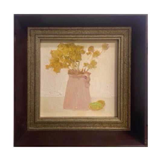 A small original oil painting featuring yellow flowers arranged in a soft pink vase, presented in a vintage-style dark wood frame with warm antique details. The artwork combines gentle tones, textured brushwork, and quiet still life composition suitable for refined interiors.