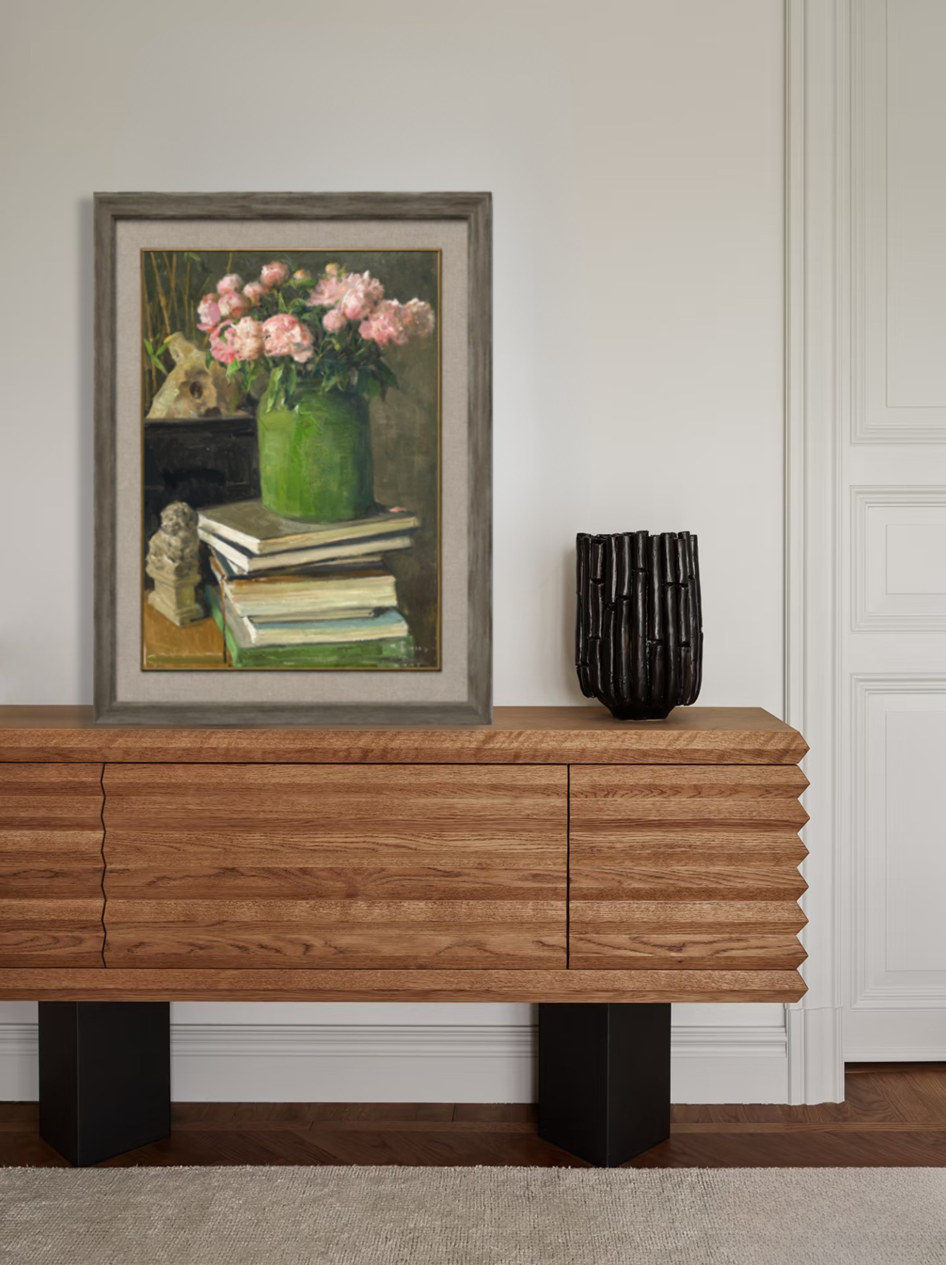 Framed still life artwork with books and flowers displayed in living room, adding a refined focal point and quiet atmosphere.