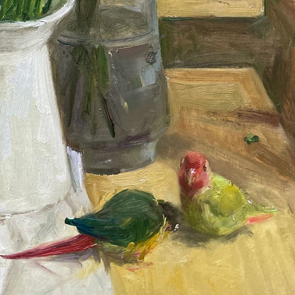 Close-up view of a colorful parrot beside flowers and books, adding character and narrative presence to the still life composition.