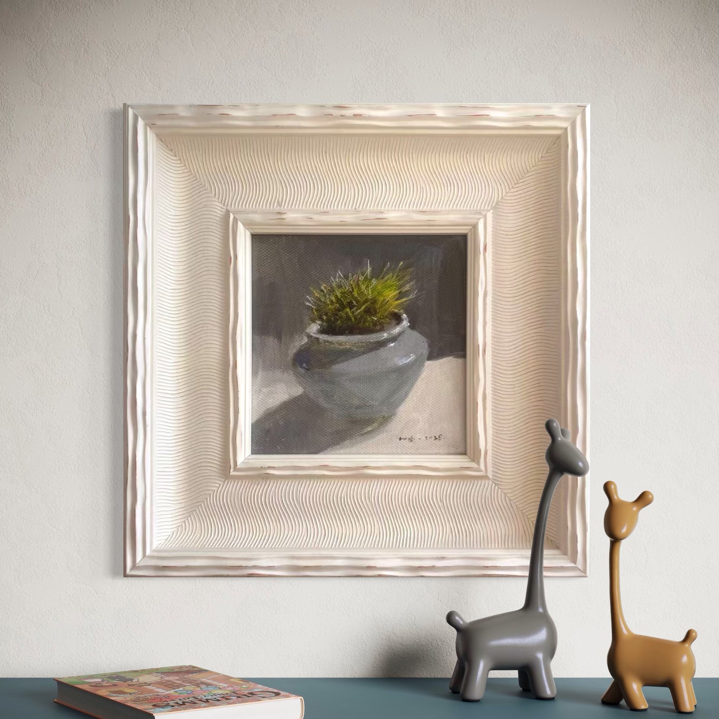 A small framed botanical oil painting displayed in a minimalist contemporary room with soft beige walls and sculptural decor, creating a refined gallery-style atmosphere