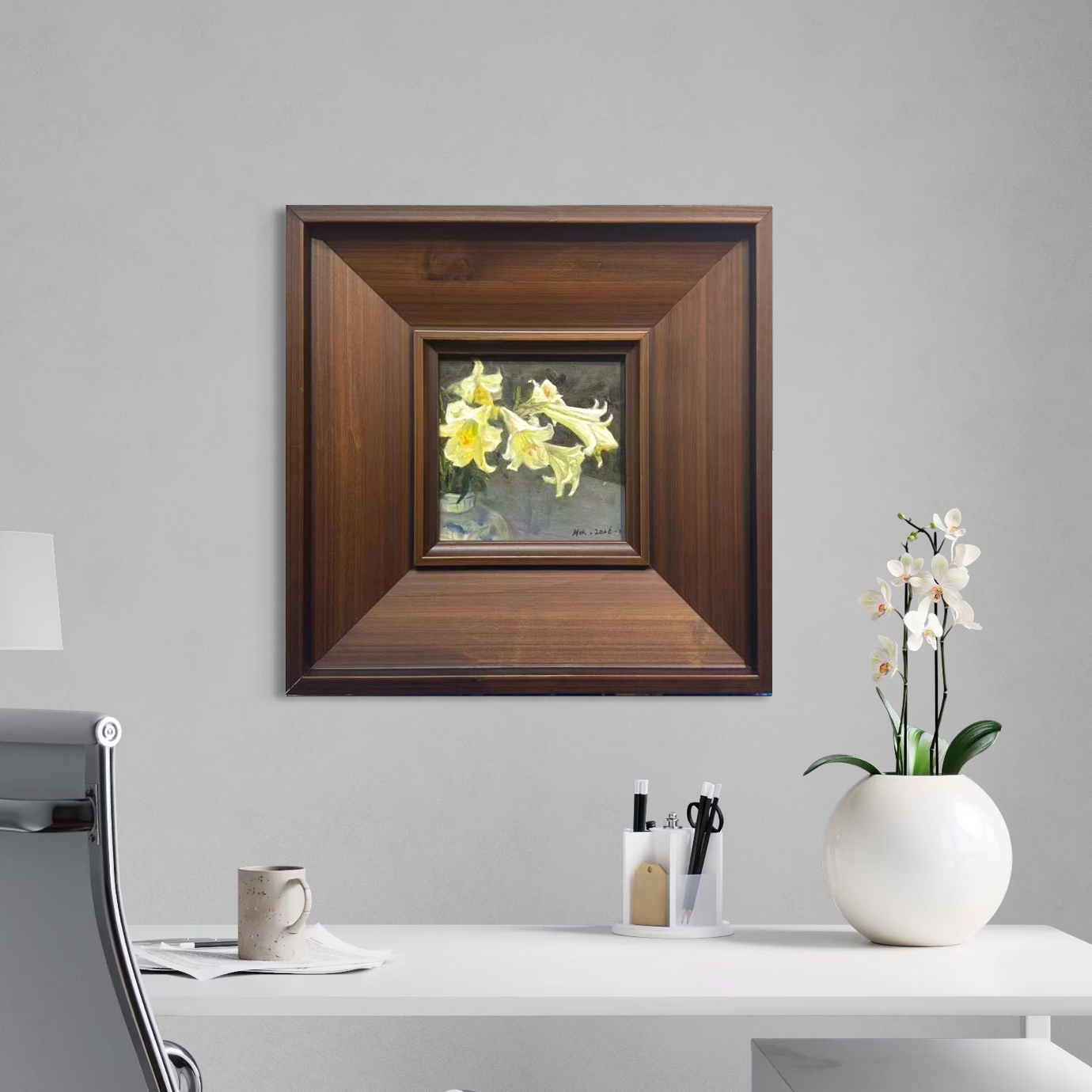 Small framed yellow floral oil painting styled in a calm minimalist interior with neutral colors and modern decorative elements.