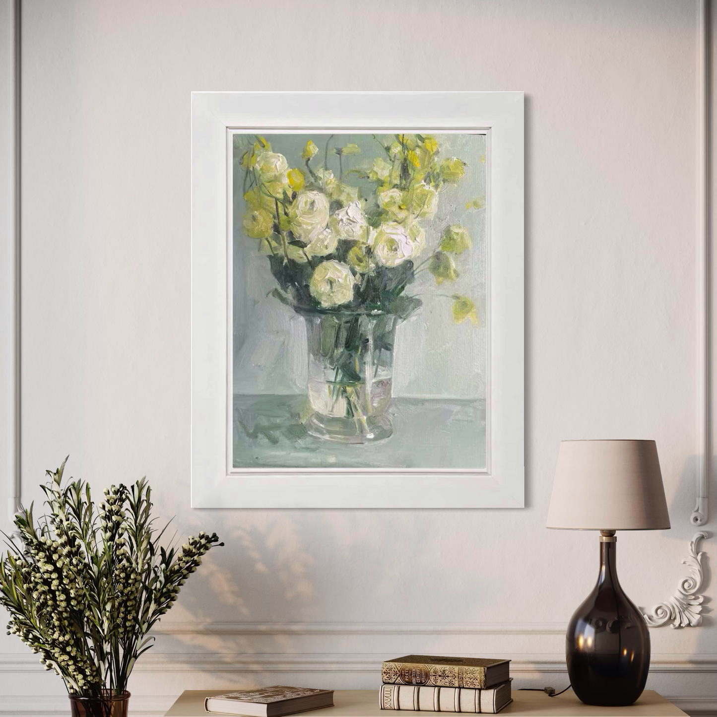 Framed white floral oil painting displayed in an elegant interior with dark sculptural decor and warm ambient tones.