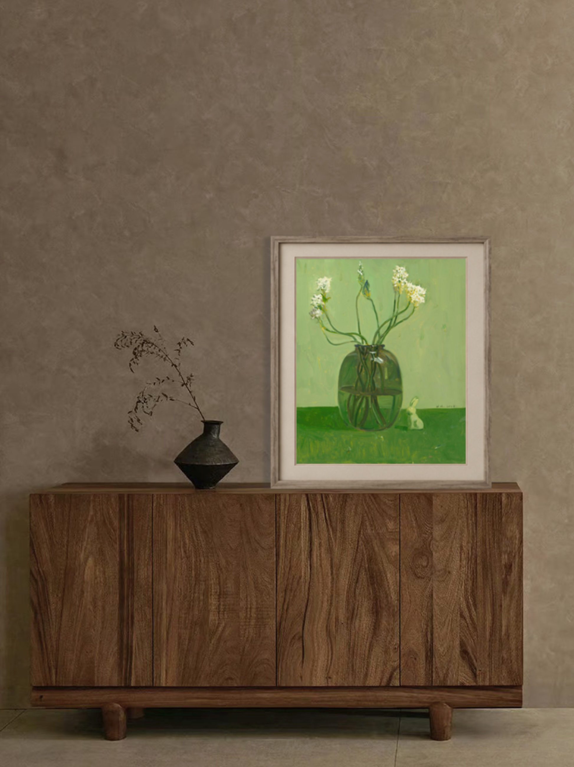 Framed original oil painting featuring white flowers in a green vase displayed above a wooden cabinet, creating a refined and peaceful focal point.