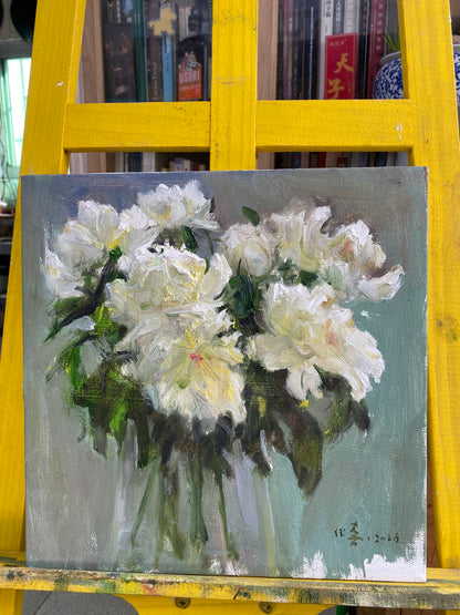 Original white peony oil painting displayed on a studio easel during the framing and presentation process.