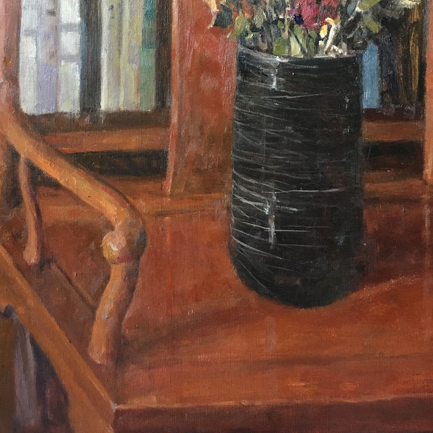 Detail of the wooden chair, tabletop, and black vase, showing the warm interior structure and balanced still life composition.
