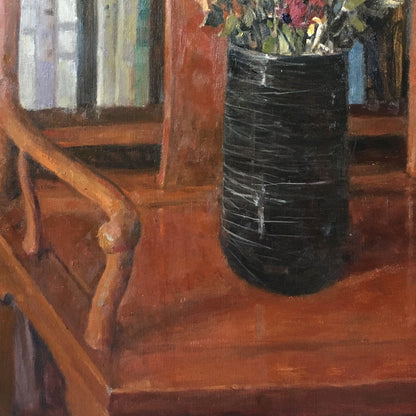 Detail of the wooden chair, tabletop, and black vase, showing the warm interior structure and balanced still life composition.