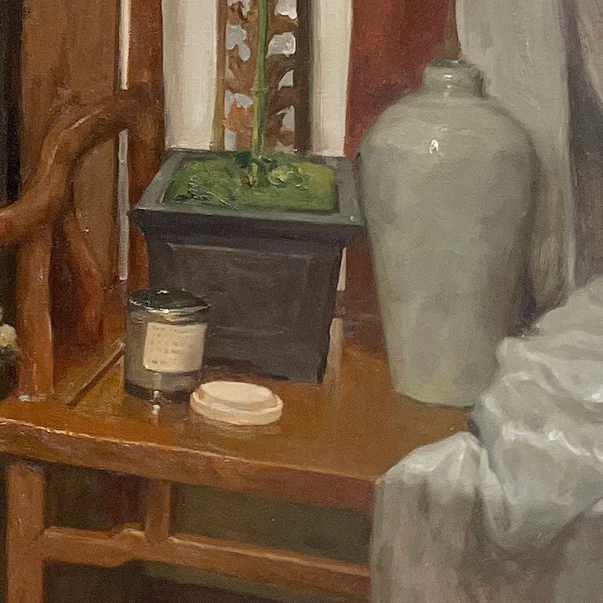 Detailed view of wooden furniture, ceramic vessels, and tabletop objects, emphasizing material richness, spatial layering, and quiet interior character.