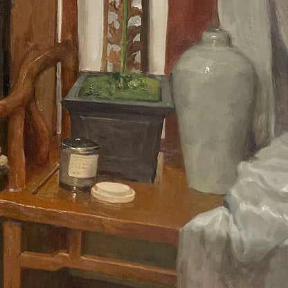 Detailed view of wooden furniture, ceramic vessels, and tabletop objects, emphasizing material richness, spatial layering, and quiet interior character.