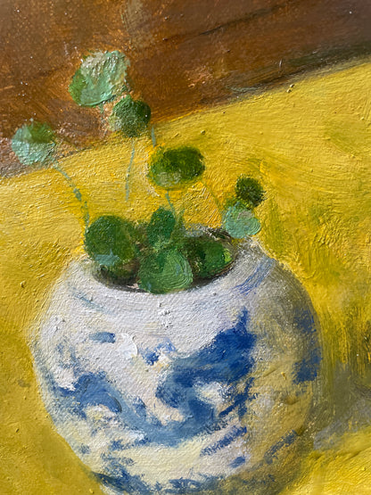 Detail of a blue and white ceramic vessel painted in a classical still life arrangement.