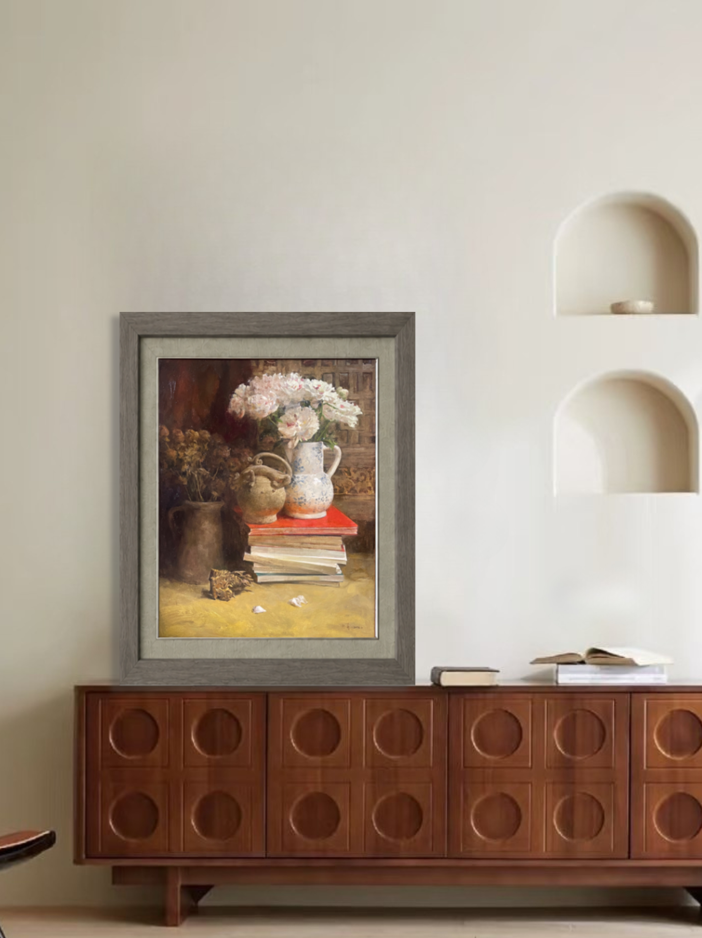 Original still life painting styled in a living room interior above a wooden cabinet.