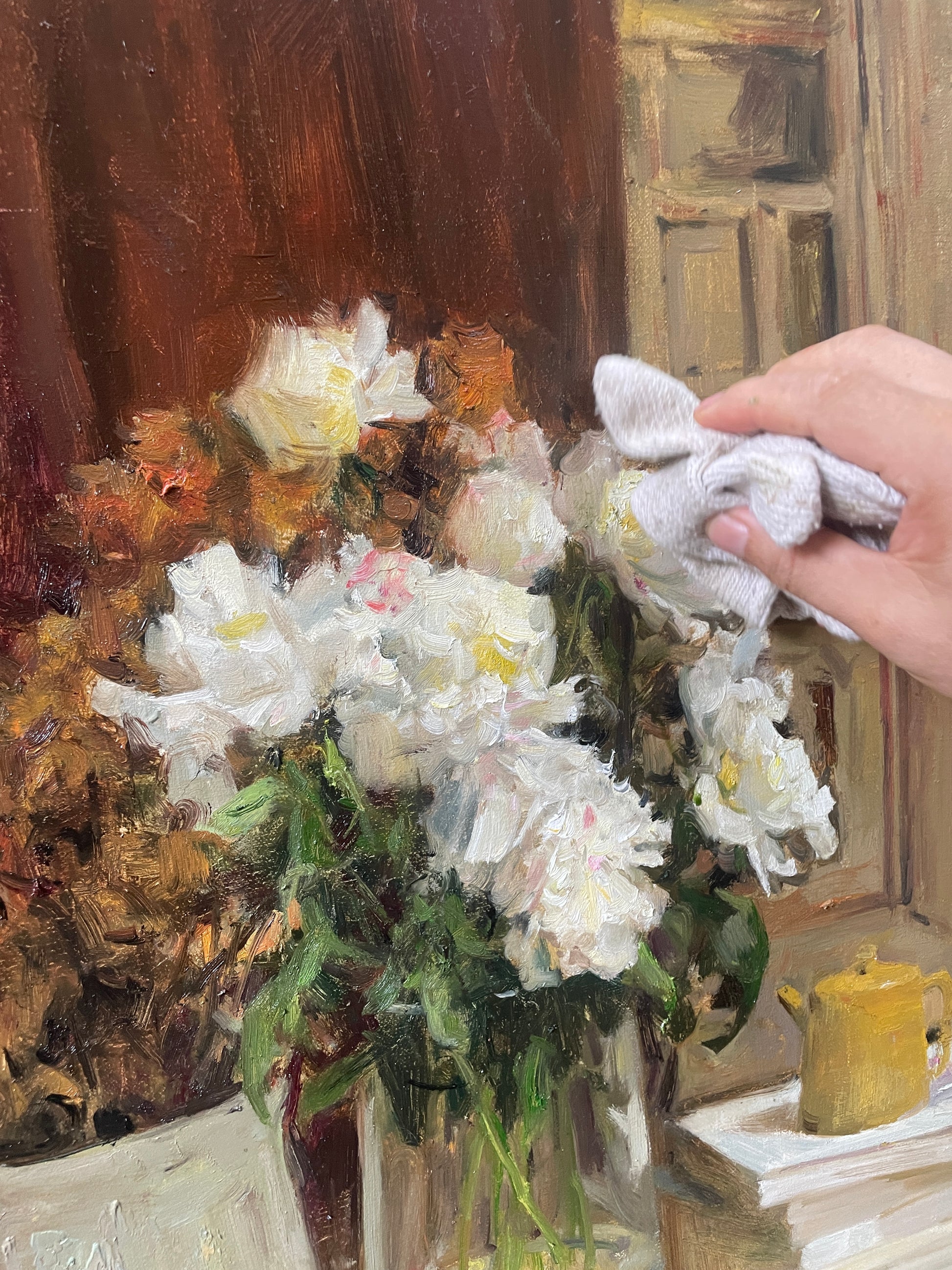 Close-up of white flowers during the painting process, showing brushwork, texture and floral details.