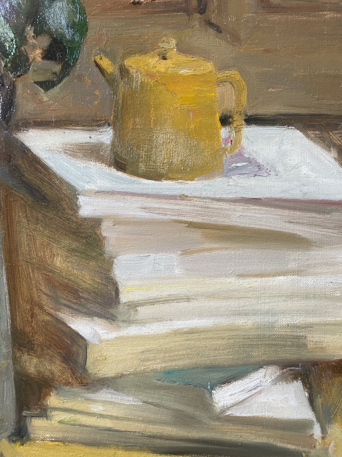 Detail showing a yellow teapot resting on stacked books within the literary still life composition.