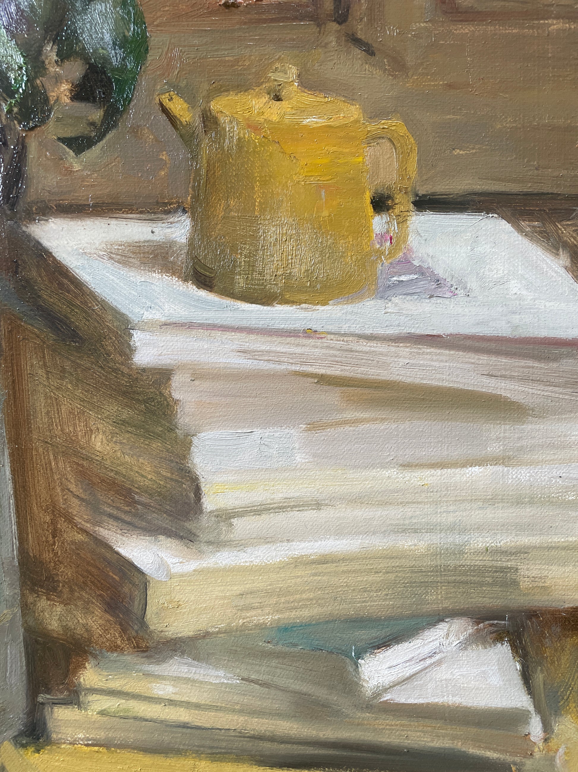 Detail showing a yellow teapot resting on stacked books within the literary still life composition.