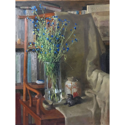 Original oil painting of a studio still life with blue wildflowers in a vase, table, and surrounding objects